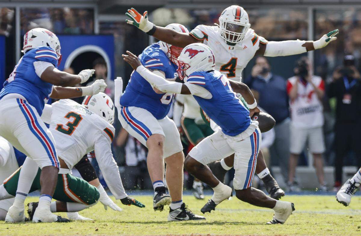 Miami Hurricanes defensive lineman Rueben Bain Jr. (4) pressures Southern Methodist University Mustangs quarterback Kevin Jennings (7) during the second half of an NCAA football game at Gerald Ford Stadium on Saturday, November 1, 2025, in Dallas, Texas.