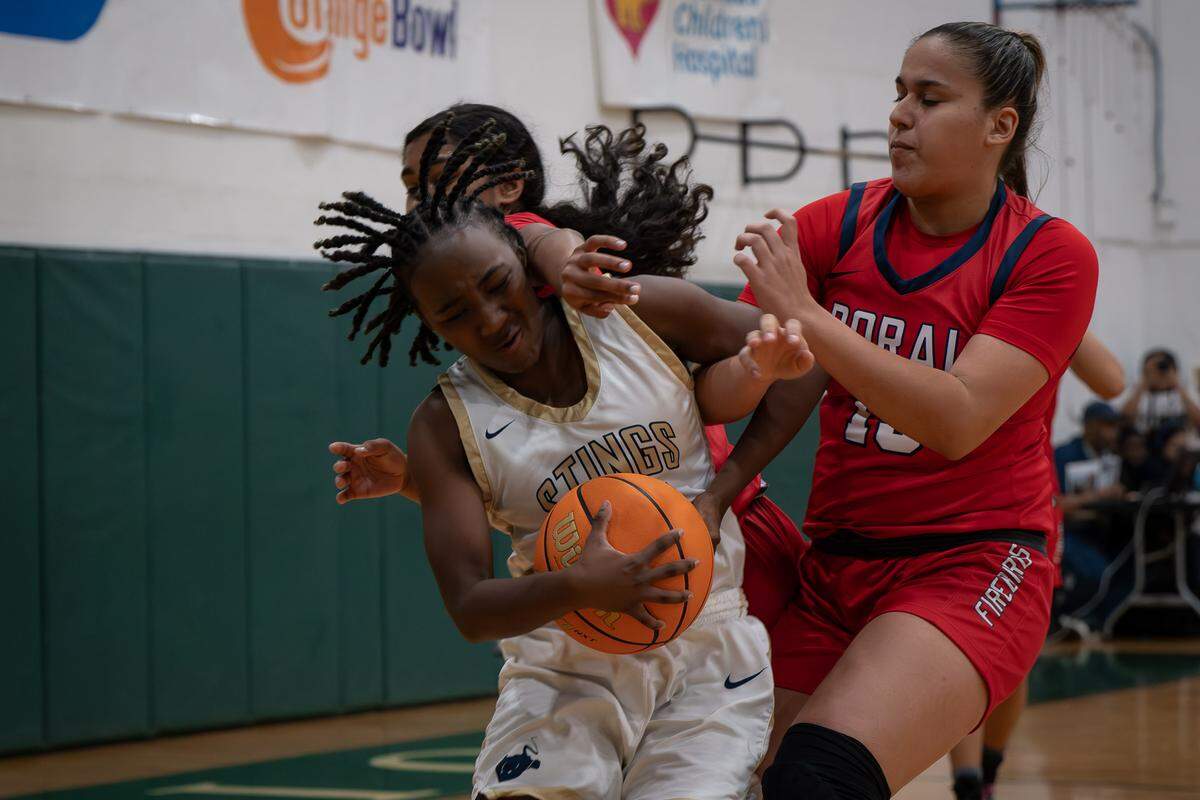 Doral Academy’s Amira Marquez tries to steal the ball from Miami High guard Kailynn Gibson during Saturday’s third place girls’ game of the Junior Orange Bowl Baseball Classic at Westminster Christian.