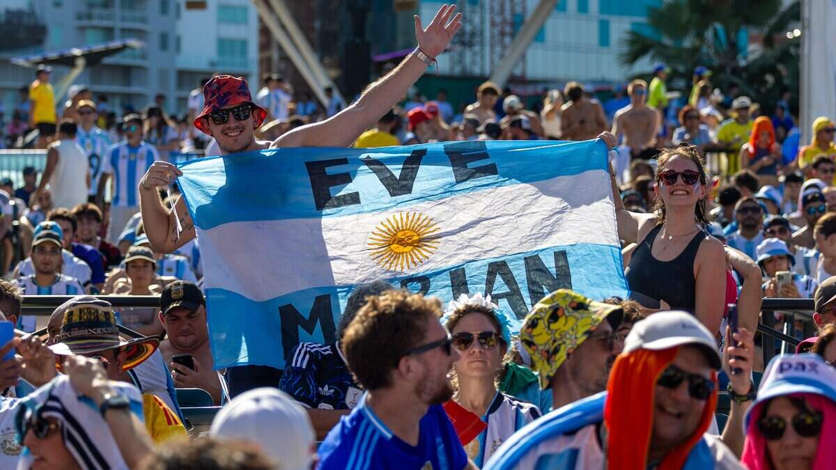 Fans hold up an Argentine flag at the FIFA Fan Festival 2026 in Bayfront Park to watch Argentina play against Cape Verde on Friday, July 3, 2026, in downtown Miami, Fla.