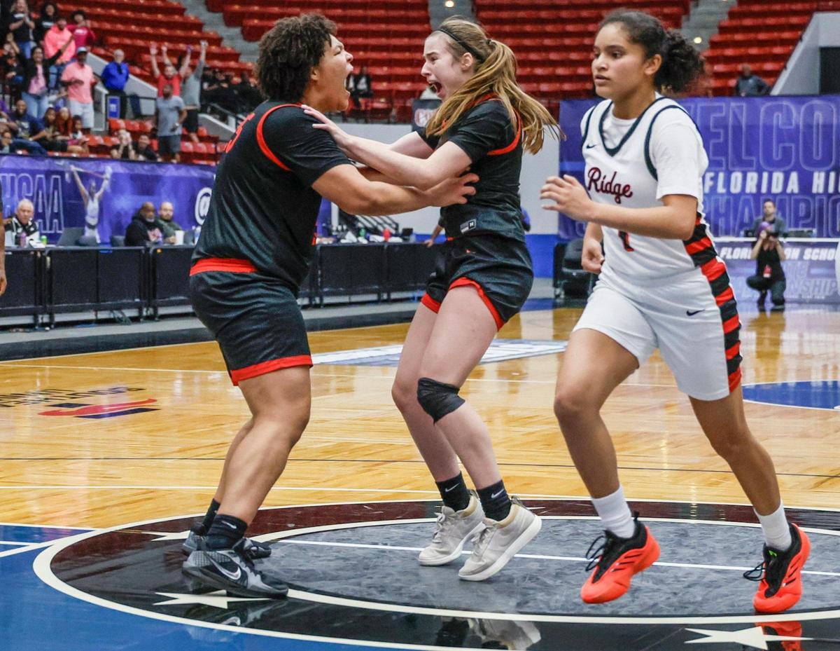 Southridge Spartans Sakura Barnes (1) runs off the court as Bloomingdale’s Izellah Kendrick (25) and Noelle Mengel (10) celebrate the win in FHSAA Class 6A Girls High School Basketball State Championship at the RP Funding Center in Lakeland, Florida on Saturday, March 8, 2025.