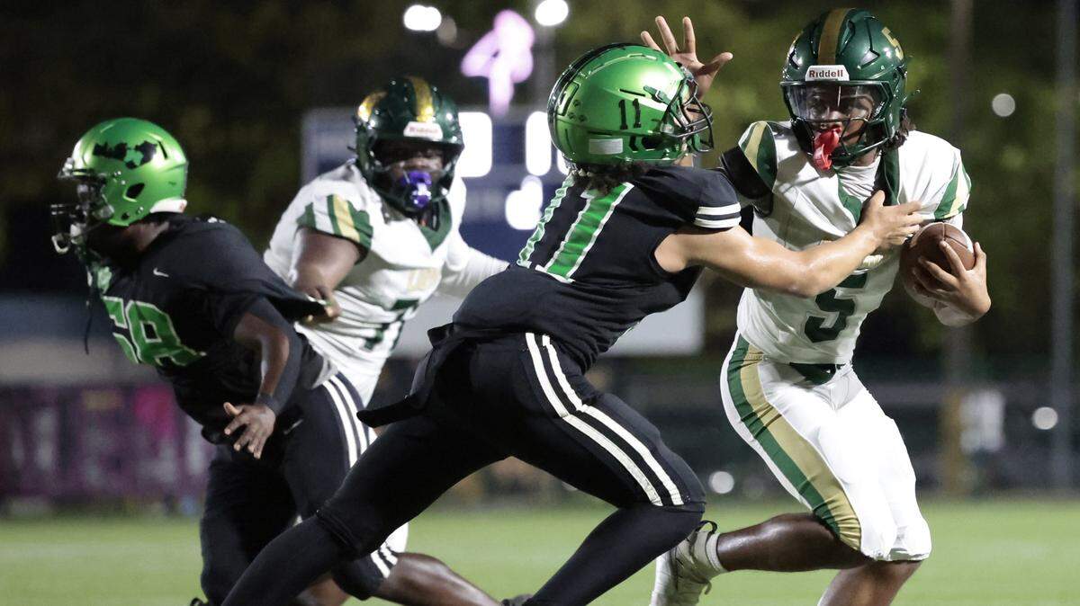 Mater Academy quarterback Dontavious Kinchens (5) battles a North Miami High School defender during their high school football game at Milander Stadium in Hialeah, Florida, on Saturday, September 27, 2025. 