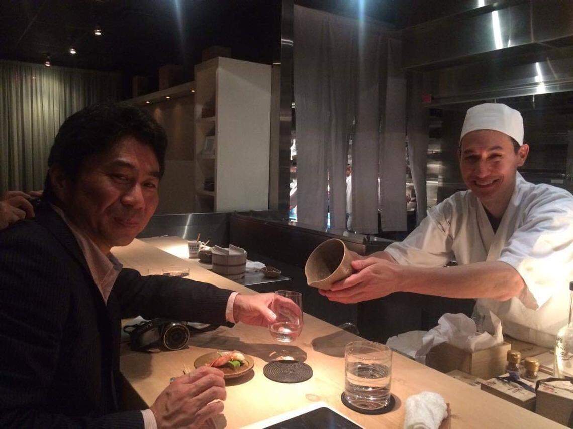 Chef and owner of Naoe Kevin Cory serves sake to his cousin and Naogen president, Junichiro Naoe.