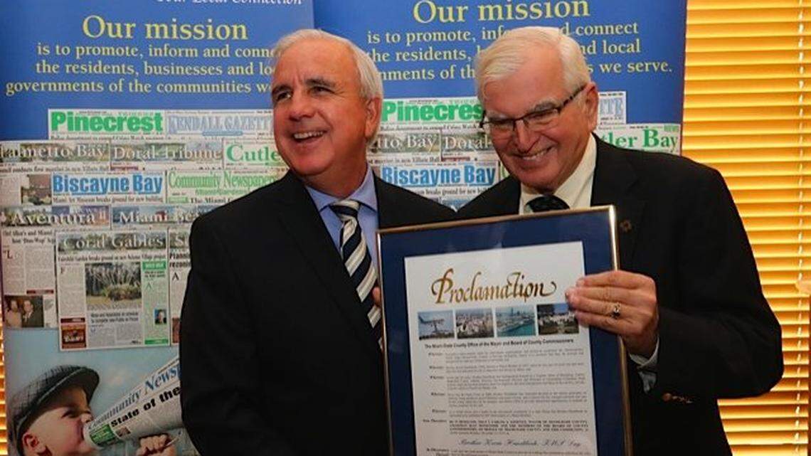 Miami-Dade County Mayor Carlos Gimenez, left, honors Brother Kevin Handibode for his service to Catholic education at a luncheon in Pinecrest in December 2016.