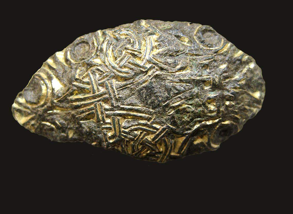 Metal artifacts, such as buckles and coins, helped determine where some burials were after the site was plowed for agriculture.