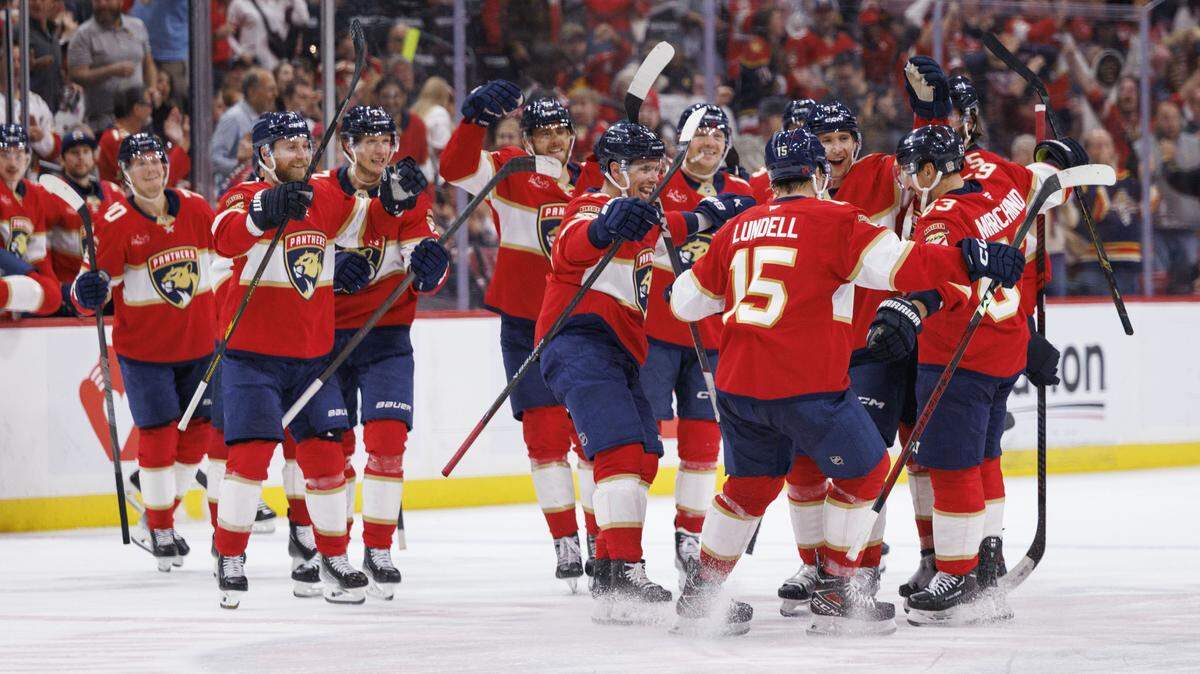 Florida Panthers left wing Brad Marchand (63), right, gets greeted by teammates on the ice after hitting 1000 career points during the third period of a game on Thursday, Nov. 13, 2025, at Amerant Bank Arena in Sunrise, Fla. The Florida Panthers won against the Washington Capitals 6-3.