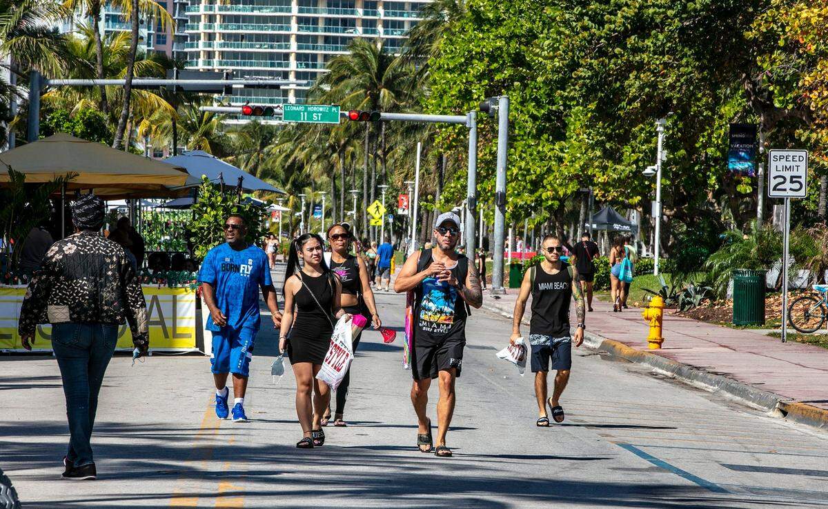 People enjoy the beautiful weather on Ocean Drive on March 2, 2021. The City of Miami Beach has implemented the ‘Vacation Responsibly’ campaign advising spring breakers of zero tolerance rules for public drunkenness, street fights, theft of any kind and illegal drug use.