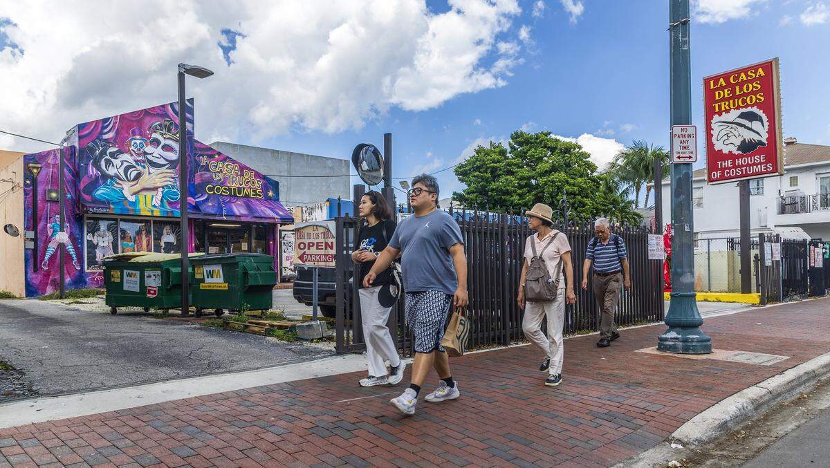 A group of people walk by the famous La Casa De Los Trucos (The House of Costumes), one of the world's oldest active costume establishments, located at 1343 SW 8th Street, Little Havana, on Wednesday, October 1, 2025.
