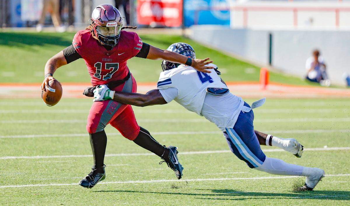 Miami Norland Vikings quarterback Ennio Yapoor (17) is pursued by Tampa Berkeley Prep Gavin Holman (4) in the first half of the Class 2M state championship at Bragg Memorial Stadium in Tallahassee, Florida, on Saturday, December 9, 2023.