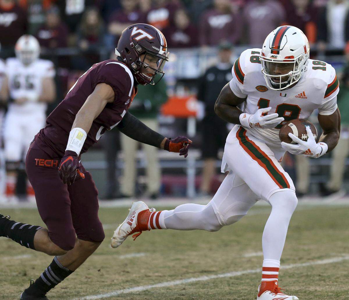 Miami receiver Lawrence Cager (18) escapes Virginia Tech defender Caleb Farley (3) in the first half of an NCAA college football game in Blacksburg, Va., Saturday, Nov. 17 2018.