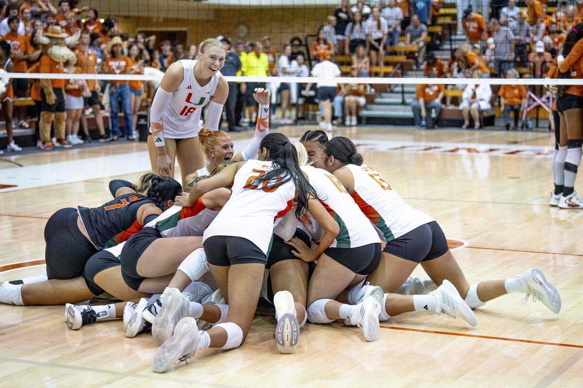 University of Miami volleyball players pile up on the court in celebration after beating No. 1-ranked Texas last Saturday in Austin, Texas.