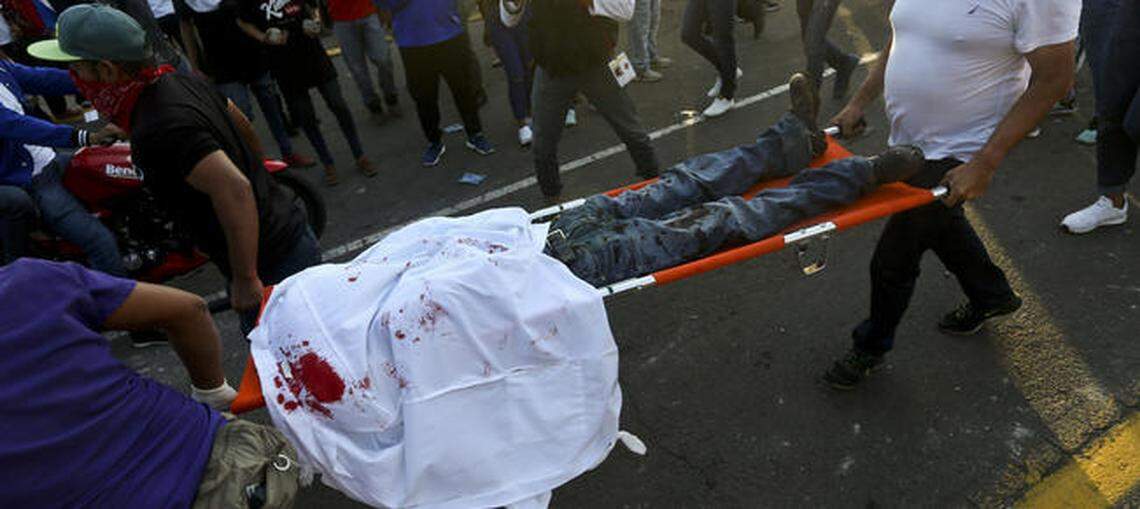 Paramedics carry away a demonstrator shot in the head after clashes erupted during a march against Nicaragua’s President Daniel Ortega in May.