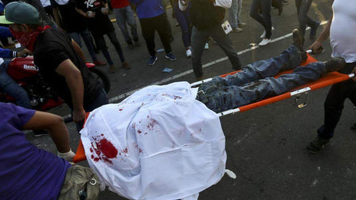 Paramedics carry away a demonstrator shot in the head after clashes erupted during a march against Nicaragua’s President Daniel Ortega in May.