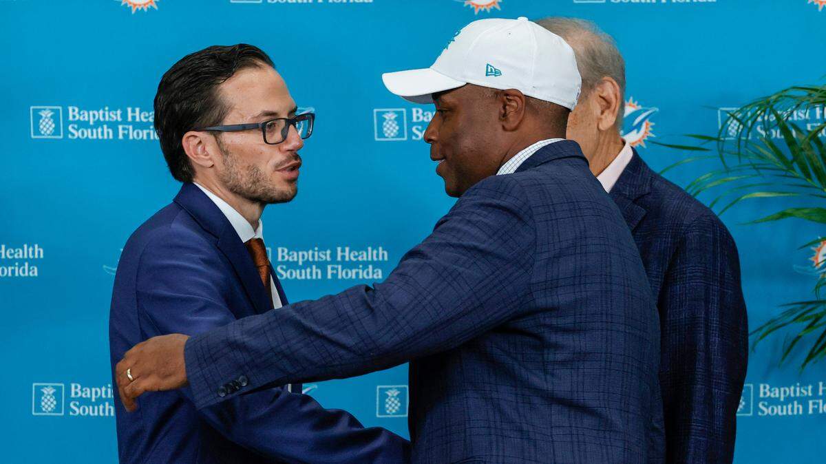 New Miami Dolphins head coach Mike McDaniel shakes hands with Dolphins general manager Chris Grier and Dolphins owner Stephen M. Ross during his introductory press conference at Baptist Health Training Complex in Hard Rock Stadium on Thursday, February 10, 2022 in Miami Gardens, Florida.