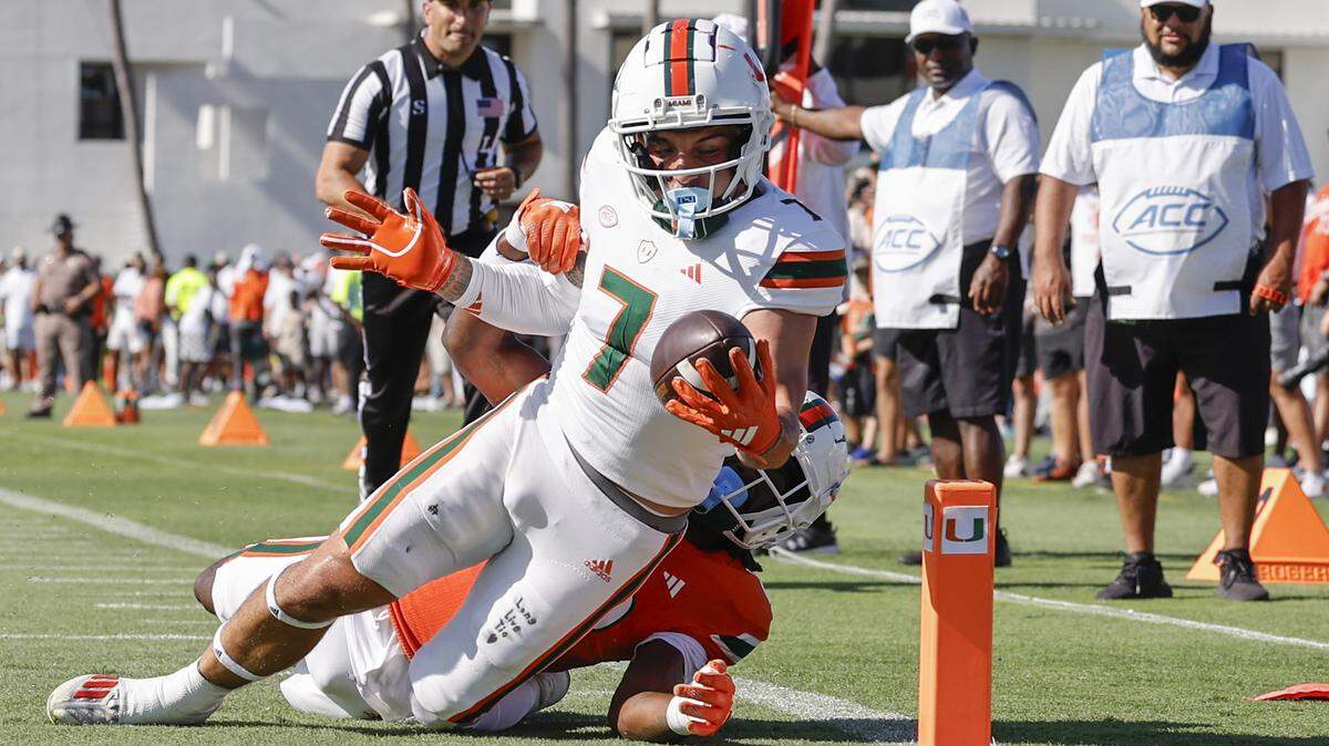 Miami Hurricanes wide receiver Xavier Restrepo (7) scores as Miami Hurricanes Savion Riley (19) attempts the stop in the first half during the Canes spring football game at the University of Miami’s Cobb Stadium in Coral Gables, Florida on Saturday, April 13, 2024.