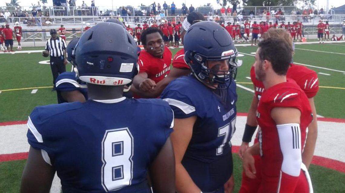 Columbus and Chaminade-Madonna captains meet at midfield prior to their kickoff classic preseason game on Friday, Aug. 17, 2018. Chaminade-Madonna’s Keontra Smith, center, was a dominant force for the Lions’ defense in the first of three two-quarter games.