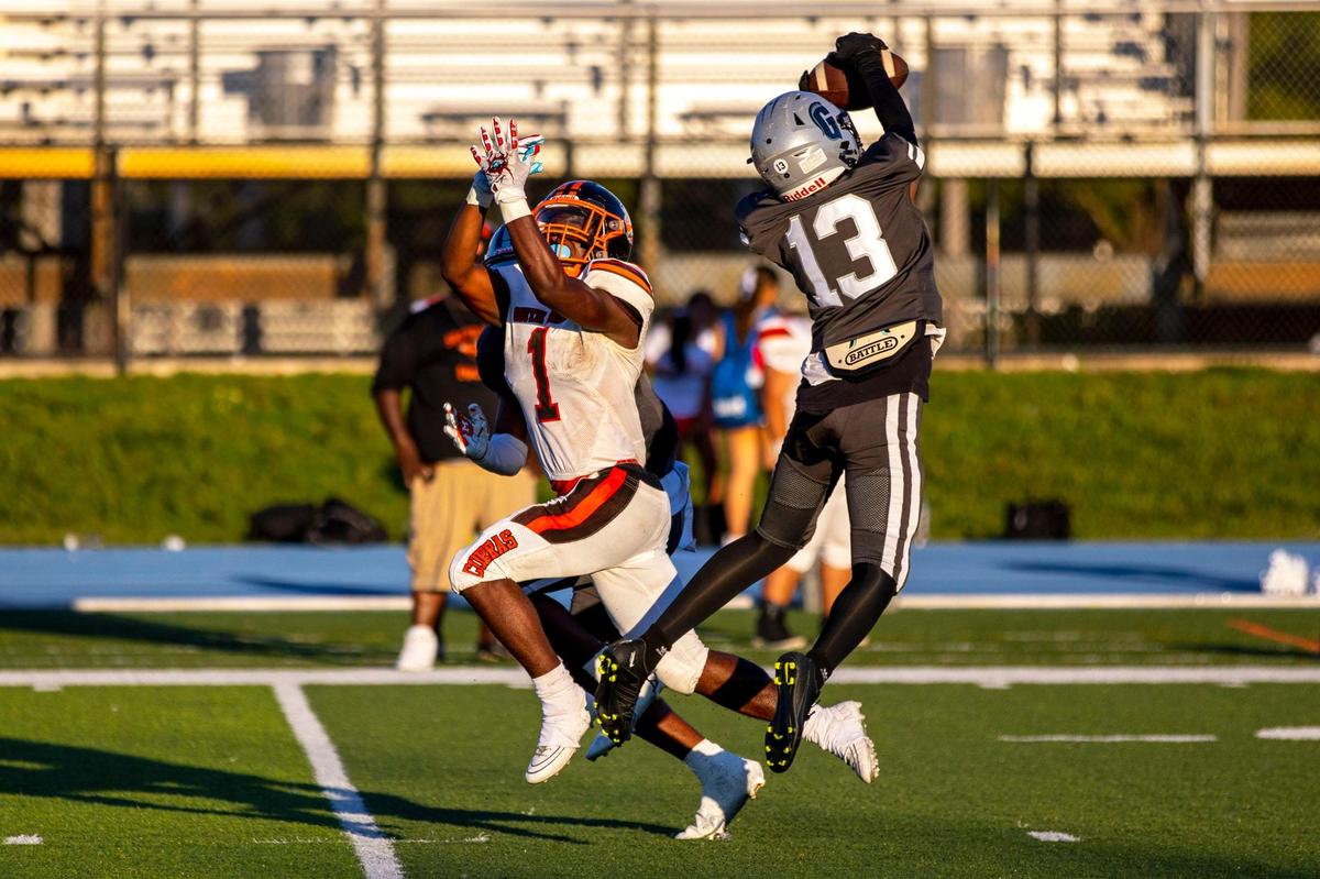 Gulliver Prep safety Champ Smith (13) intercepts the ball before South Miami High receiver Levy Miller (1) could make the catch during a high school football game at Tropical Park Stadium in Miami, Florida, on Thursday, October 27, 2022.