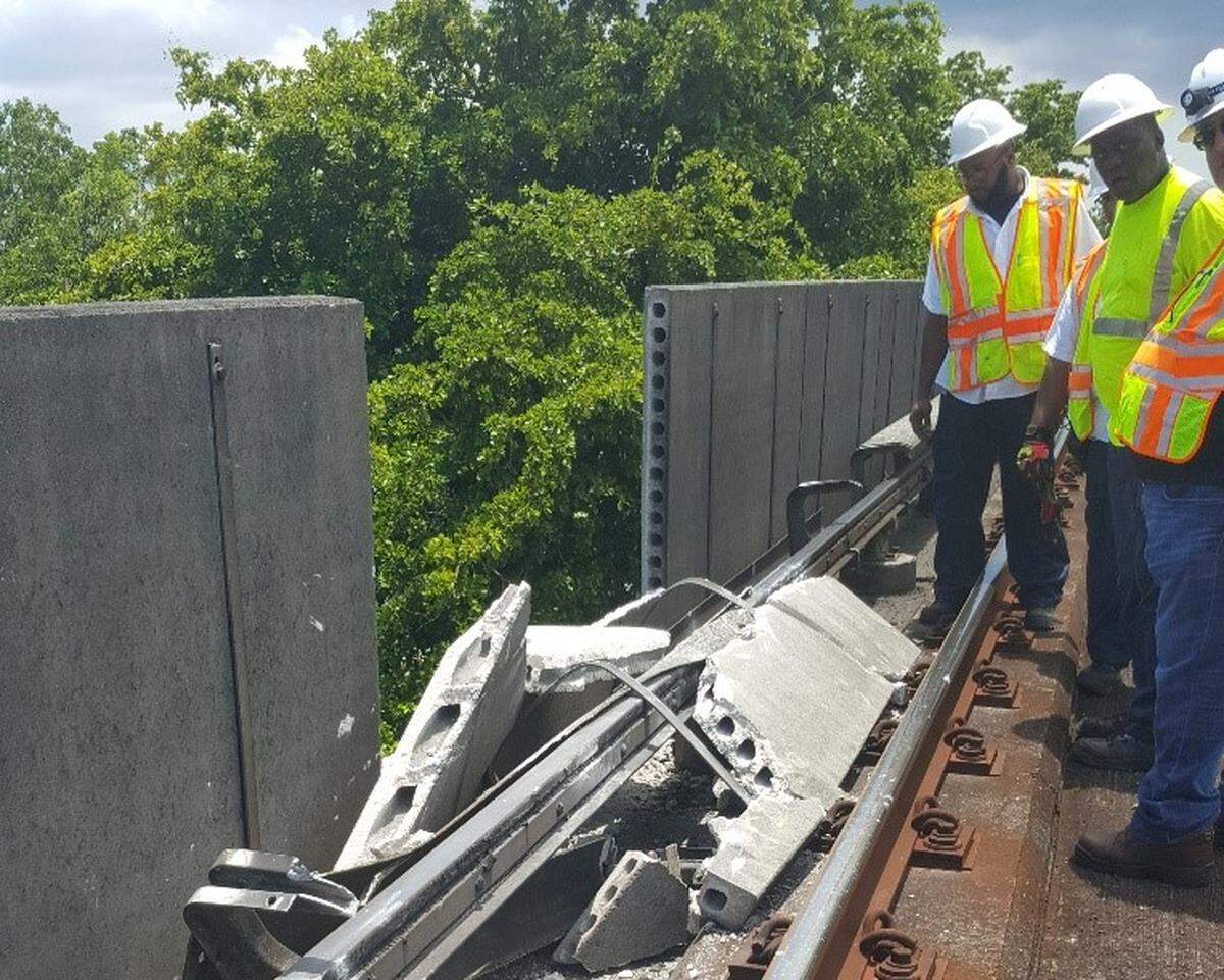 A Miami-Dade repair crew surveys the damage of a Metrorail acoustical barrier that failed in July 3, 2018. A passing train hit the debris, causing delays throughout the system. County consultants warned Miami-Dade the barriers needed to be replaced in 2012, and the replacement work is slated to begin in the spring of 2020. Photo provided by Miami-Dade County Transportation and Public Works Department.