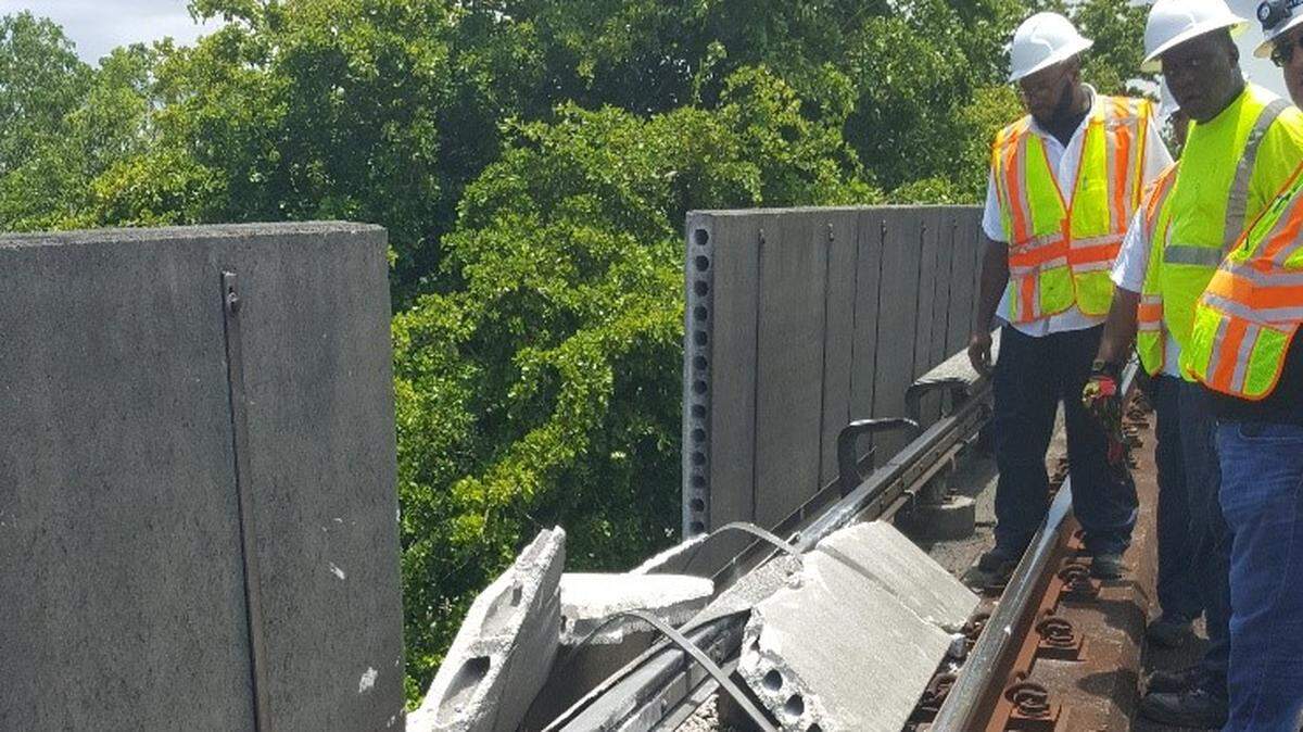 A Miami-Dade repair crew surveys the damage of a Metrorail acoustical barrier that failed in July 2018. A passing train hit the debris, causing delays throughout the system. County consultants warned Miami-Dade the barriers needed to be replaced in 2012. Photo provided by Miami-Dade County Transportation and Public Works Department.