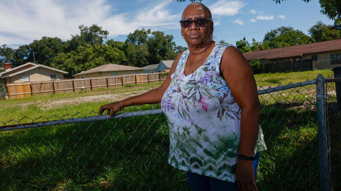 Barbara Glover, 65, poses for a portrait at the site of what used to be her home Friday, Sept. 22, 2023 in the Ybor City area of Tampa. Glover’s home was damaged after a tree fell on it during Hurricane Ian last year.