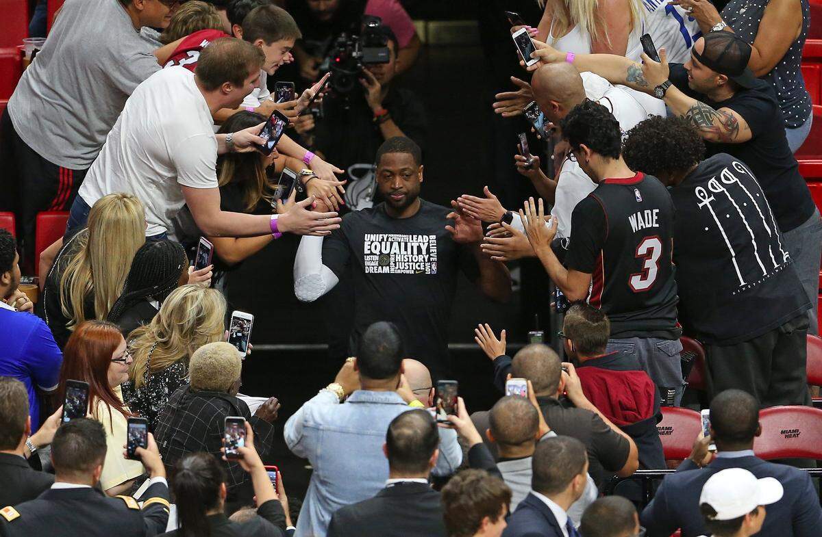 Miami Heat guard Dwyane Wade runs into the court before the start of an NBA basketball game against the Milwaukee Bucks at the AmericanAirlines Arena in Miami on Friday, February 9, 2018.