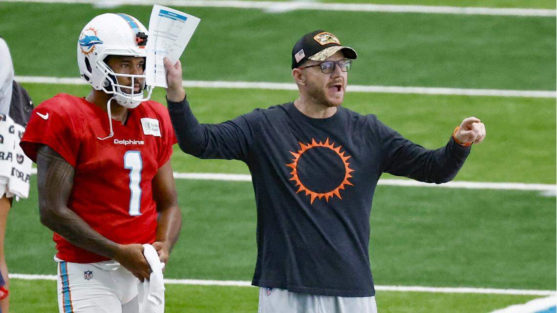 Miami Dolphins quarterbacks and passing game coordinator coach Darrell Bevell works with quarterback Tua Tagovailoa (1) during practice drills at the Baptist Health Training Complex in Miami Gardens on Wednesday, August 23, 2023.