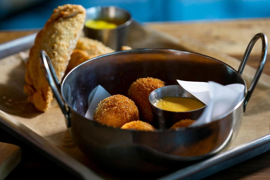 Jamon croquetas with nativo key beer cheese and Cuban sandwich empanadas with a yellow mustard aioli is prepared at Cerveceria La Tropical in Wynwood.