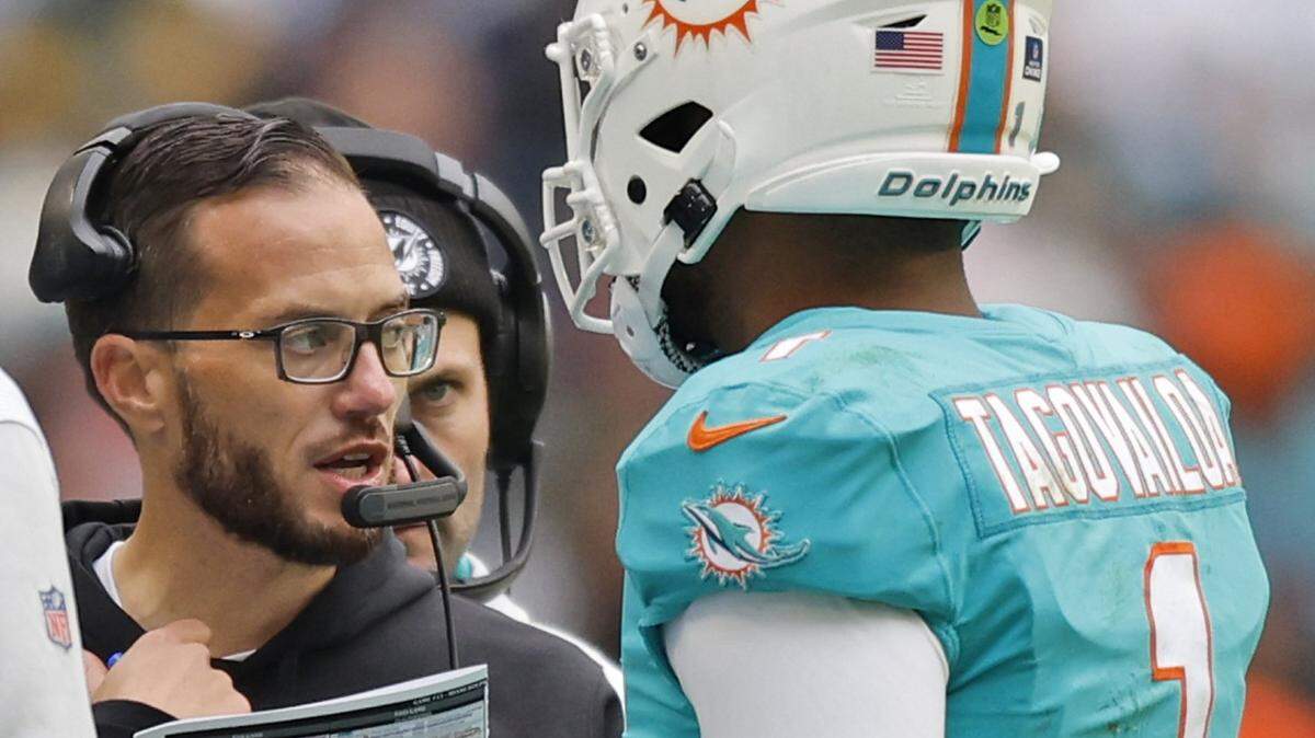 Miami Dolphins head coach Mike McDaniel talks with Miami Dolphins quarterback Tua Tagovailoa (1) in the second quarter during the game against the Green Bay Packers at Hard Rock Stadium in Miami Gardens, Florida on Sunday, December 25, 2022.