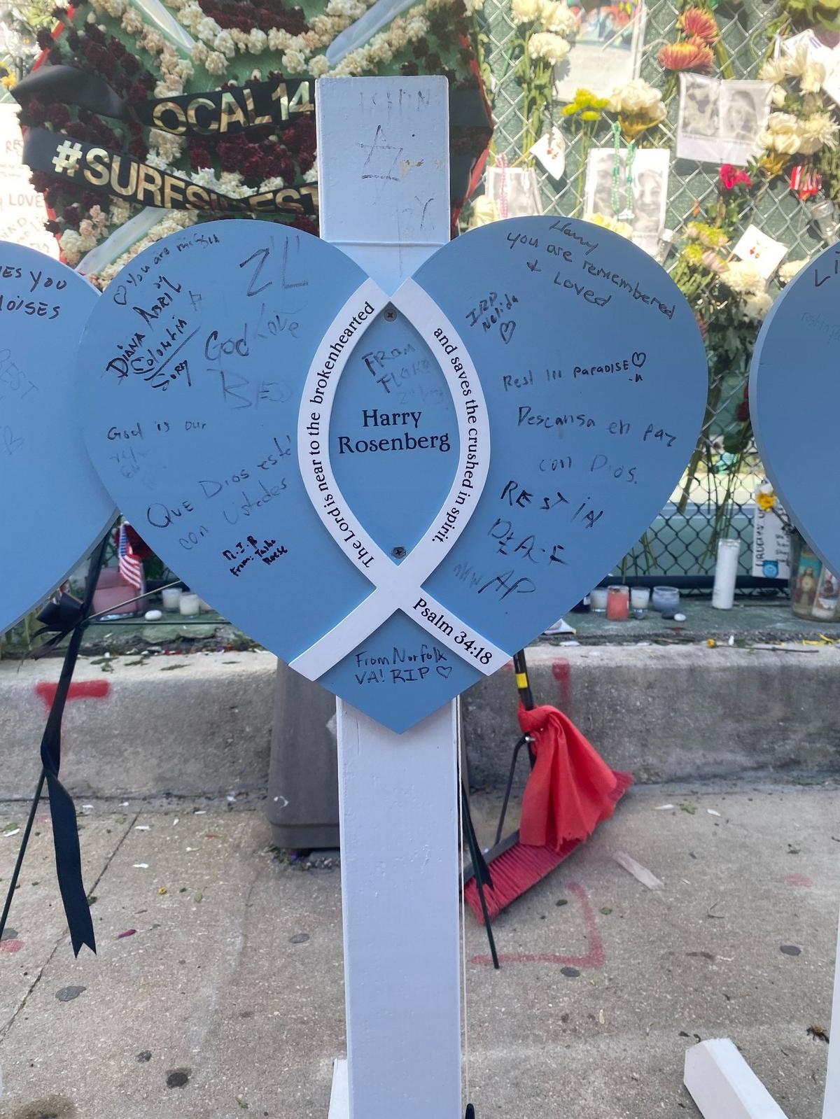 The marker of Harry Rosenberg, which stands before the memorial wall of the Surfside condo collapse victims, displays messages from people all over.