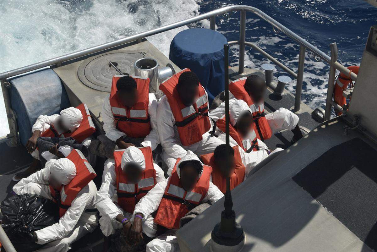 Interdicted Haitian migrants sit aboard a Coast Guard Guard 45-foot Response Boat-Medium about 10 miles east of Lake Worth, Florida, April 24, 2021. The Coast Guard Cutter Charles Sexton’s crew repatriated 72 Haitian migrants to Haiti on April 27, 2021.