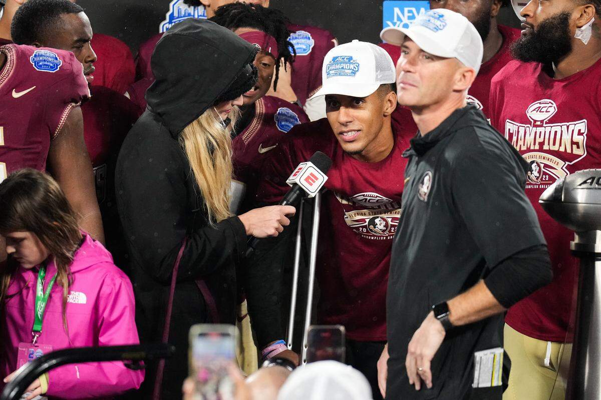 Dec 2, 2023; Charlotte, NC, USA; Florida State Seminoles quarterback Jordan Travis (13) does an interview after winning the ACC Championship game against the Louisville Cardinals at Bank of America Stadium.