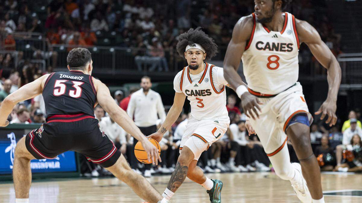 Miami Hurricanes guard Tre Donaldson (3) drives the ball down the court as Louisville Cardinals forward Vangelis Zougris (53) defends in the second half of their NCAA basketball game at the Watsco Center on Saturday, March 7, 2026, in Coral Gables, Fla.