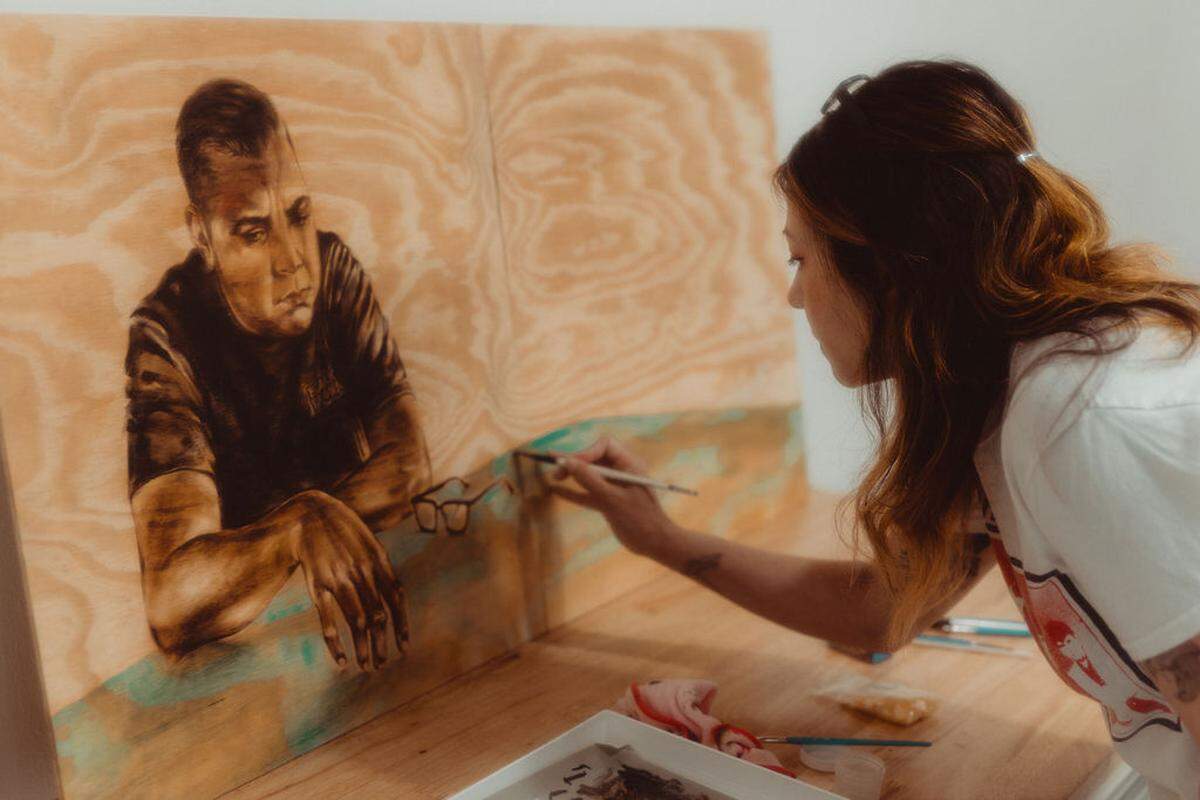 Artist Shizu Saldamando works on a portrait at the Fountainhead Arts residency in Miami.
