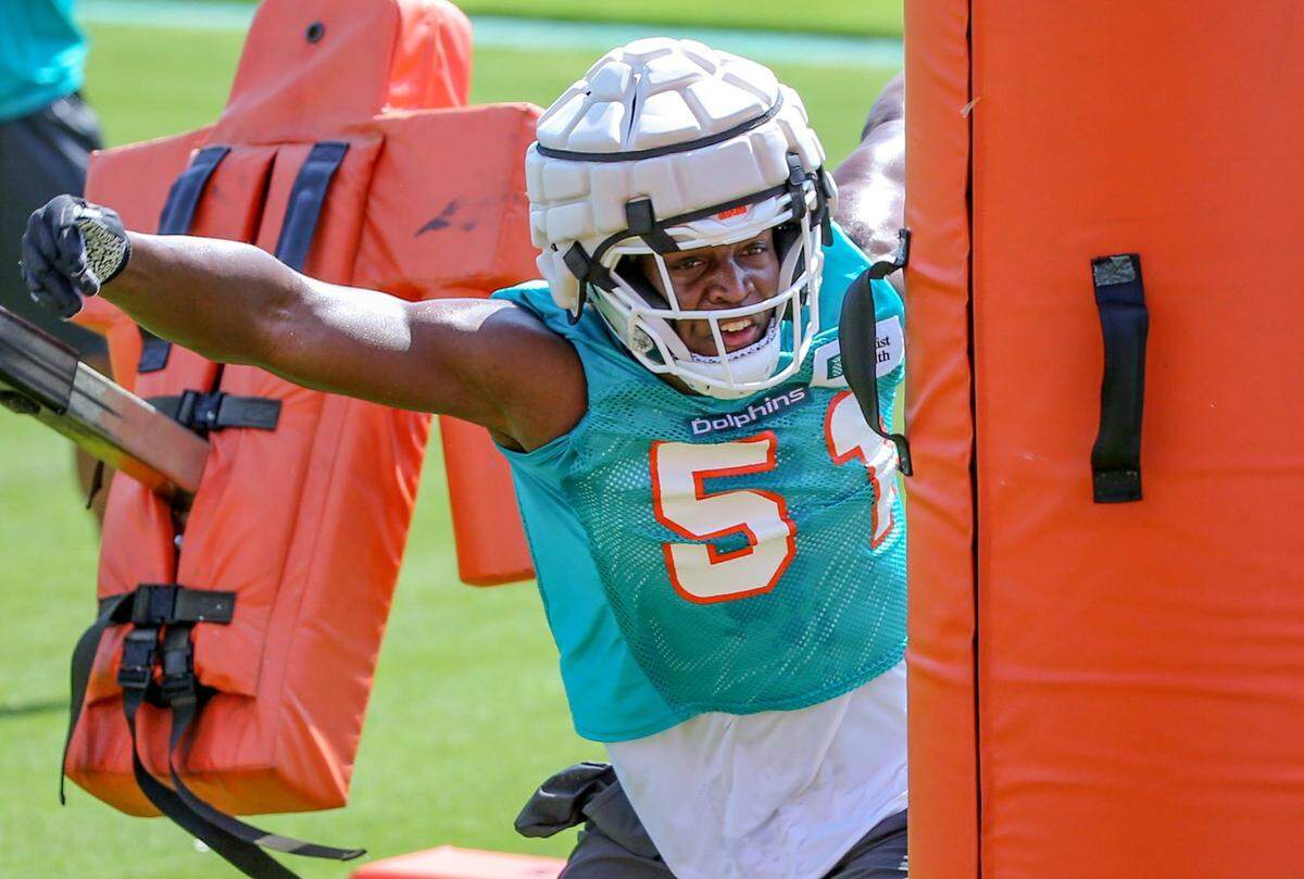 Miami Dolphins linebacker Channing Tindall (51) works with practice dummies during Dolphins Rookie Minicamp at the Baptist Health Training Complex in Miami Gardens on Saturday, May 14, 2022.