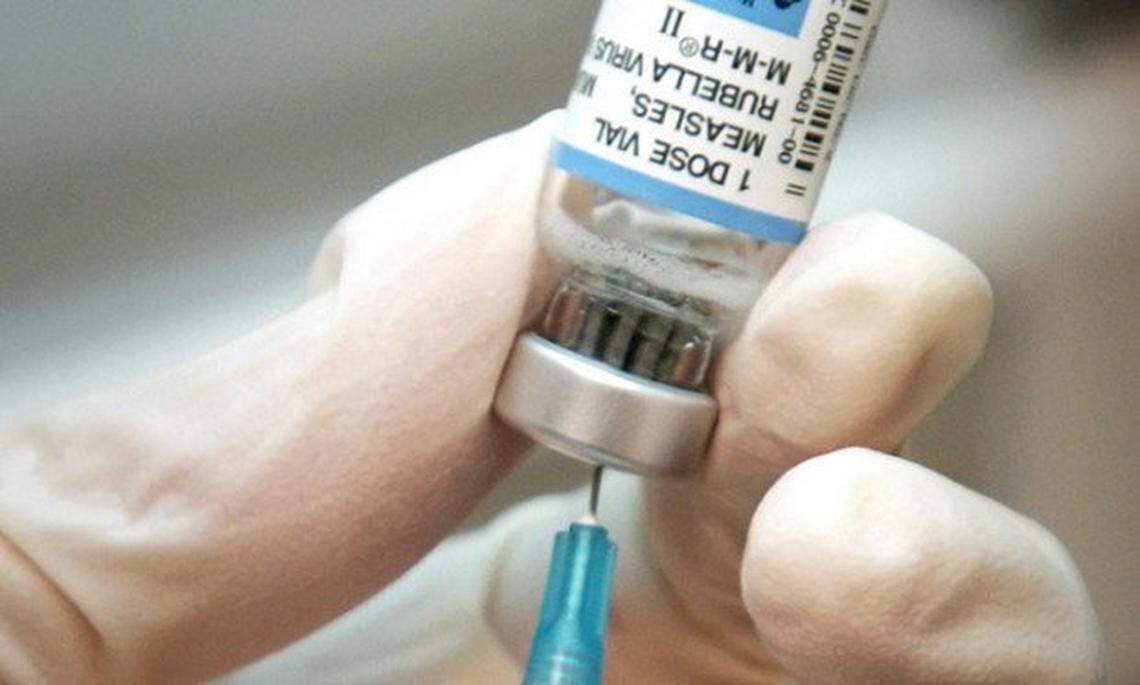 A nurse draws a dose of mumps-measles-rubella, or MMR, vaccine. A major measles outbreak in 2006 traced to Disneyland brought criticism down on the small but vocal movement among parents to opt out of vaccinations for their children.