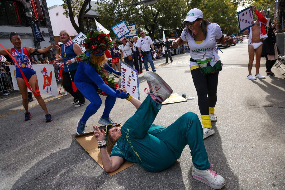 Fake breakdancer Kat Sitton, center, got down but needed help getting up as she and her troupe made light of the Summer Olympics.