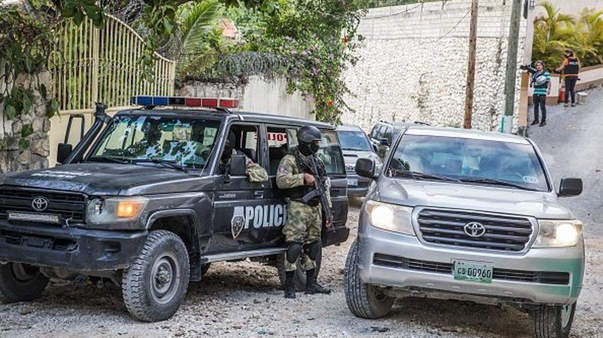 Police stand guard outside the residence of late Haitian President Jovenel Moise in Port-au-Prince on July 15, 2021, in the wake of his assassination on July 7, 2021. - The assassination of Jovenel Moise by armed mercenaries was planned in the neighboring Dominican Republic, say Haitian police, who announced the detention of the slain president's chief bodyguard and three other members of his security detail. The United States has sent members of the Federal Bureau of Investigation (FBI), State Department, Justice Department, National Security Council and Department of Homeland Security to Haiti. (Photo by Valerie Baeriswyl / AFP) (Photo by VALERIE BAERISWYL/AFP via Getty Images)
