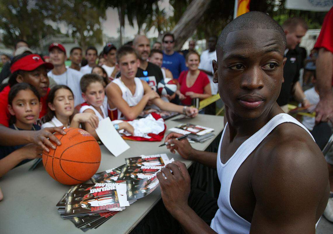 At Flamingo Park on Miami Beach the Heat’s first round pick in the NBA draft Dwyane Wade signs autographs for waiting fans after one-on-one with Caron Butler during “Street Heat” match-up on Sept. 12, 2003.