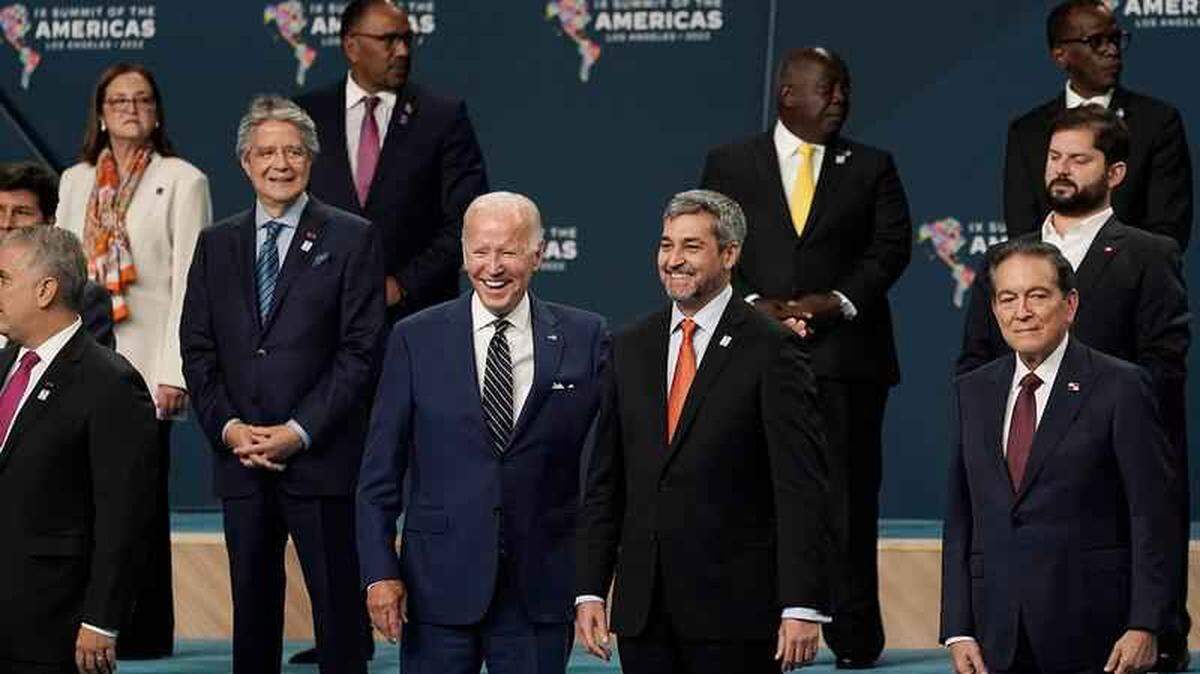 President Biden puts his arm around Paraguay President Mario Abdo Benitez as they participate in a photo with delegation heads at the Summit of the Americas.