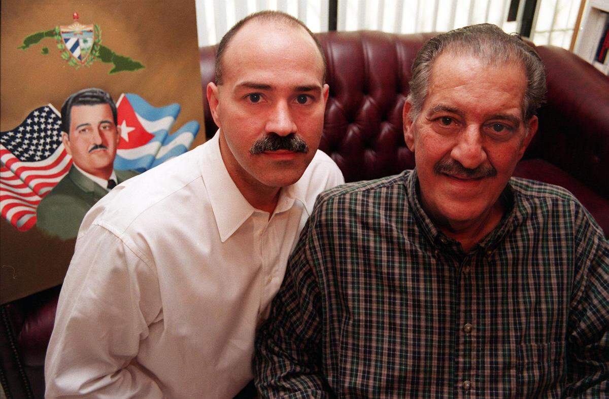 Alberto Milian and his father Emilio Milian pose together at the family’s home in 1999.