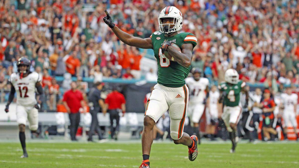 Miami Hurricanes wide receiver Dee Wiggins (8) scores on a 67 yard pass from quarterback Jarren Williams (15) in the first quarter as the University of Miami Hurricanes host the Louisville Cardinals on Saturday, November 9, 2019.