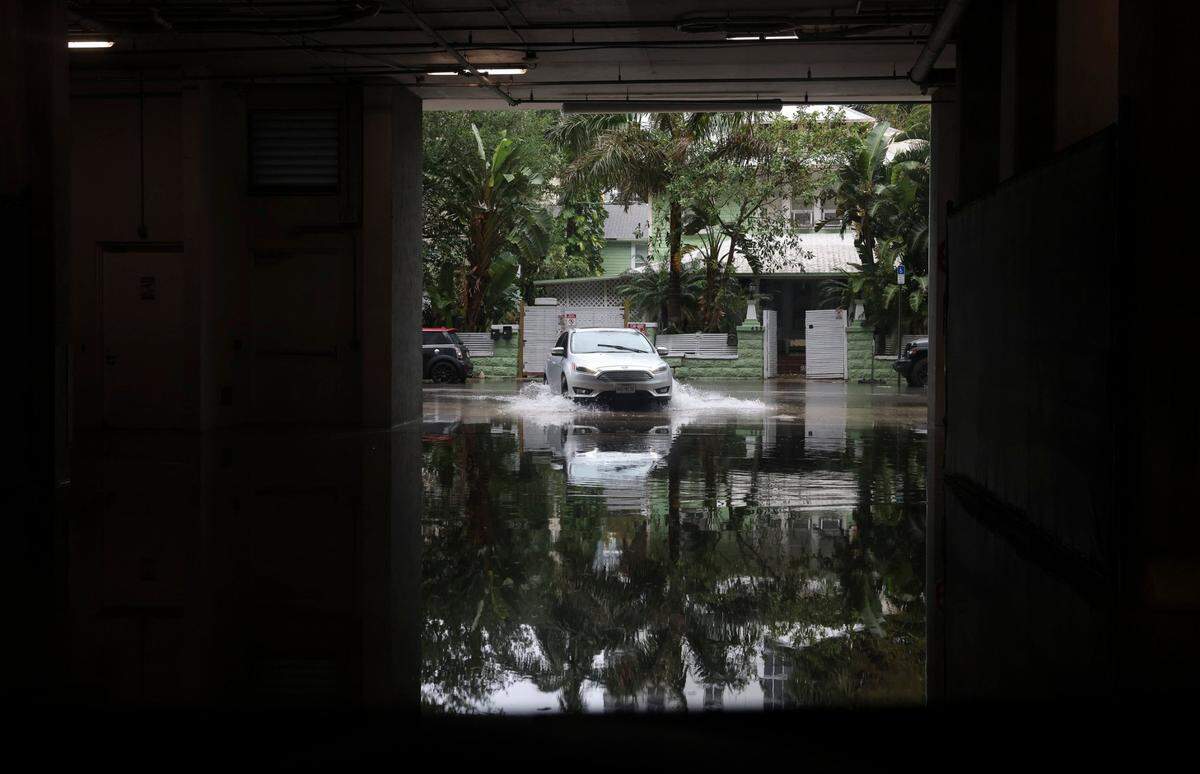 A car pulls into a parking garage on 25th street during a rainstorm in Miami in 2023.
