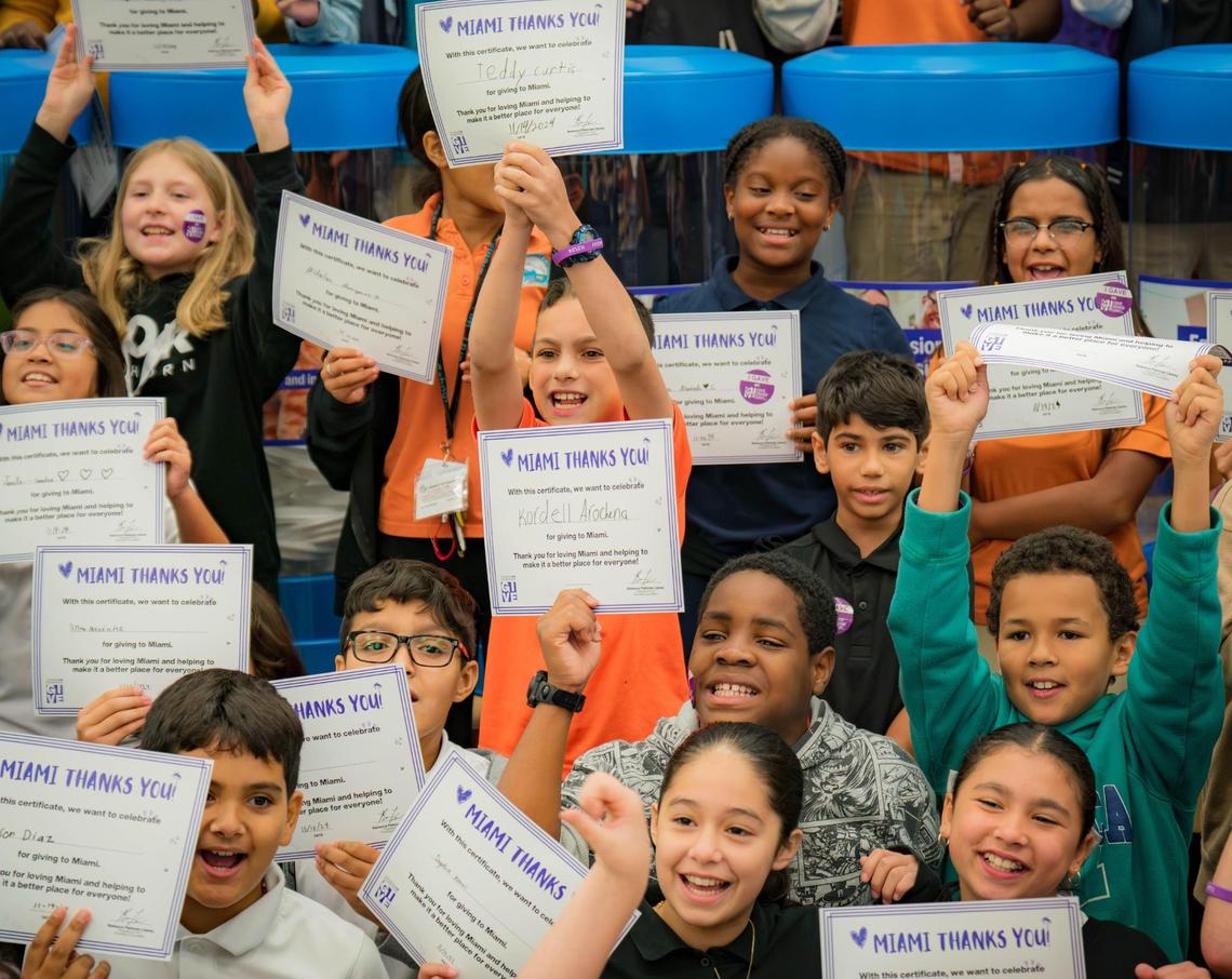 Students at Edward L. Whigham Elementary School hold their certificates after a presentation on philanthropy and nonprofits by the Give Miami Foundation on Thursday, Nov. 14, 2024, in Cutler Bay, Fla.
