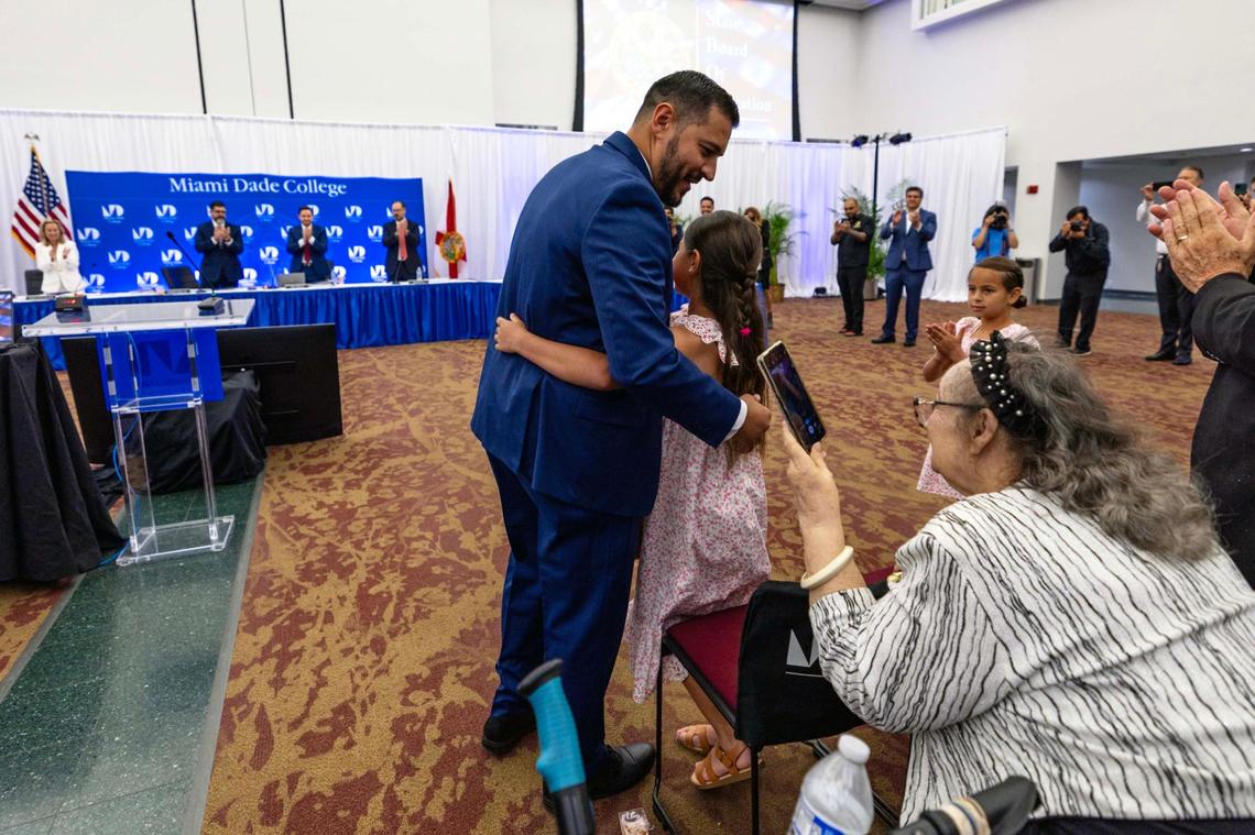 Anastasios “Stasi” Kamoutsas hugs one of his daughters as he reacts to being selected as the next commissioner of education during a Florida State Board of Education meeting at Miami Dade College Wolfson Campus park on Wednesday, June 4, 2025, in Miami, Fla.