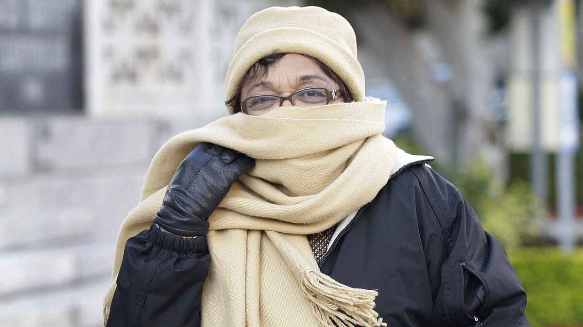 No, you’re not going to have to break out the winter clothes this weekend in Miami as this woman did when temperatures dipped into the 30s in this file photo from Dec. 27, 2010. But after months of stifling temperatures, a predicted low in the 60s for South Florida on the weekend of Oct. 27-28, 2018, should feel like a treat.