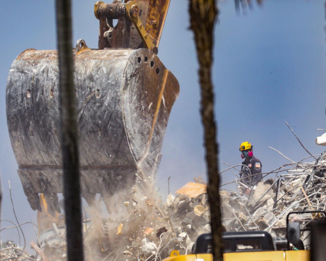 A search team member works the debris field of the collapsed 12-story oceanfront condo, Champlain Towers South, in Surfside on Saturday, July 10, 2021.