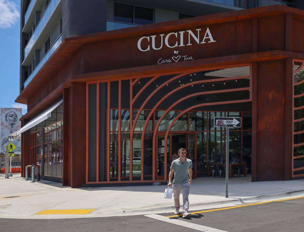 A patron exits the new Casa Tua Cucina in Miami's Wynwood Art District on Thursday, April 16, 2026. Casa Tua Cucina in Wynwood, a spacious, upscale Italian food hall and restaurant features an open layout with high ceilings, communal tables, and multiple dedicated dining areas-making it suitable for both intimate dinners and larger group gatherings.