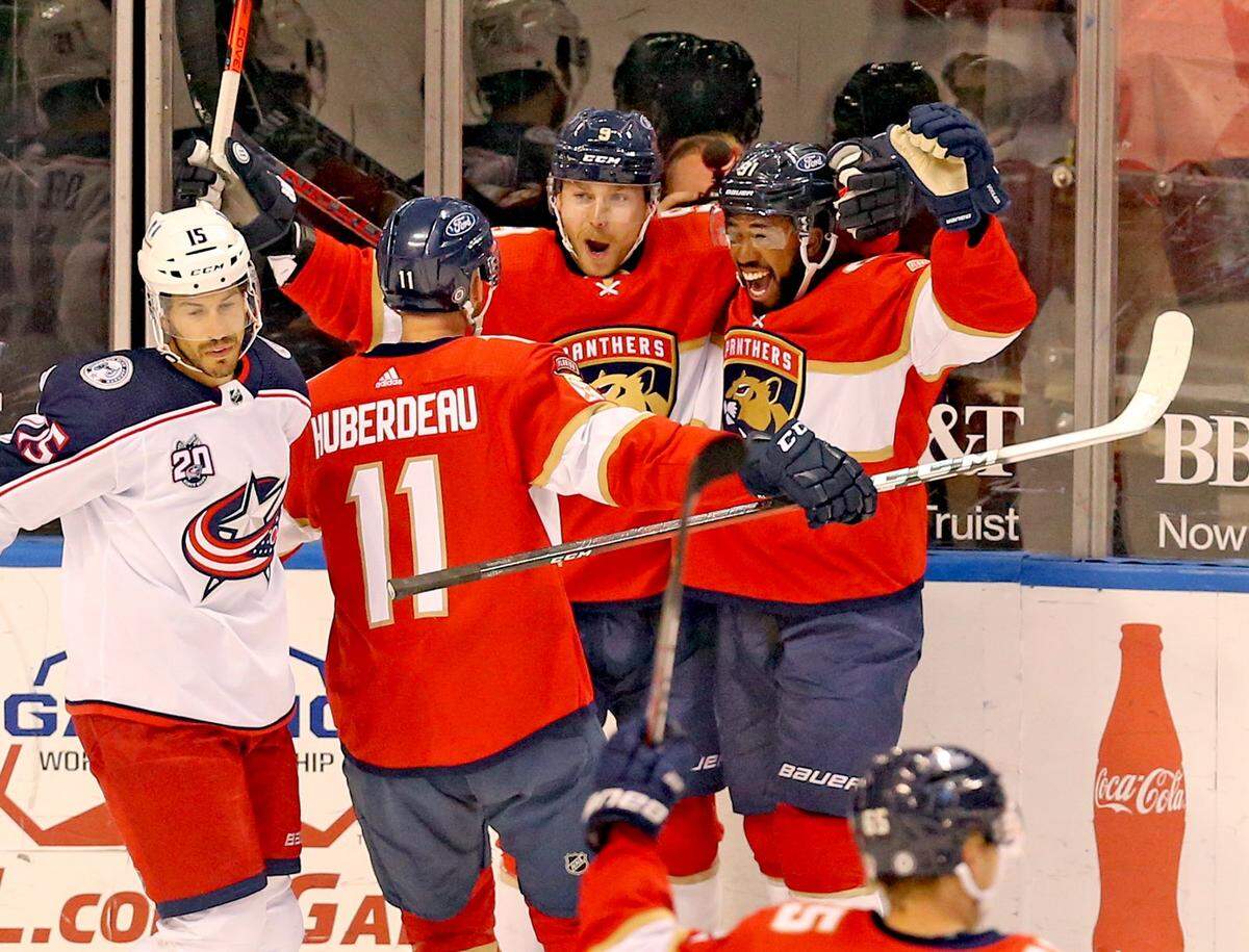 Florida Panthers Sam Bennett (9) scores and celebrates with Jonathan Huberdeau (11) and Anthony Duclair (91) as they play the Columbus Blue Jackets in the first period at the BB&T Center in Sunrise, Florida, Tuesday, April 20, 2021.