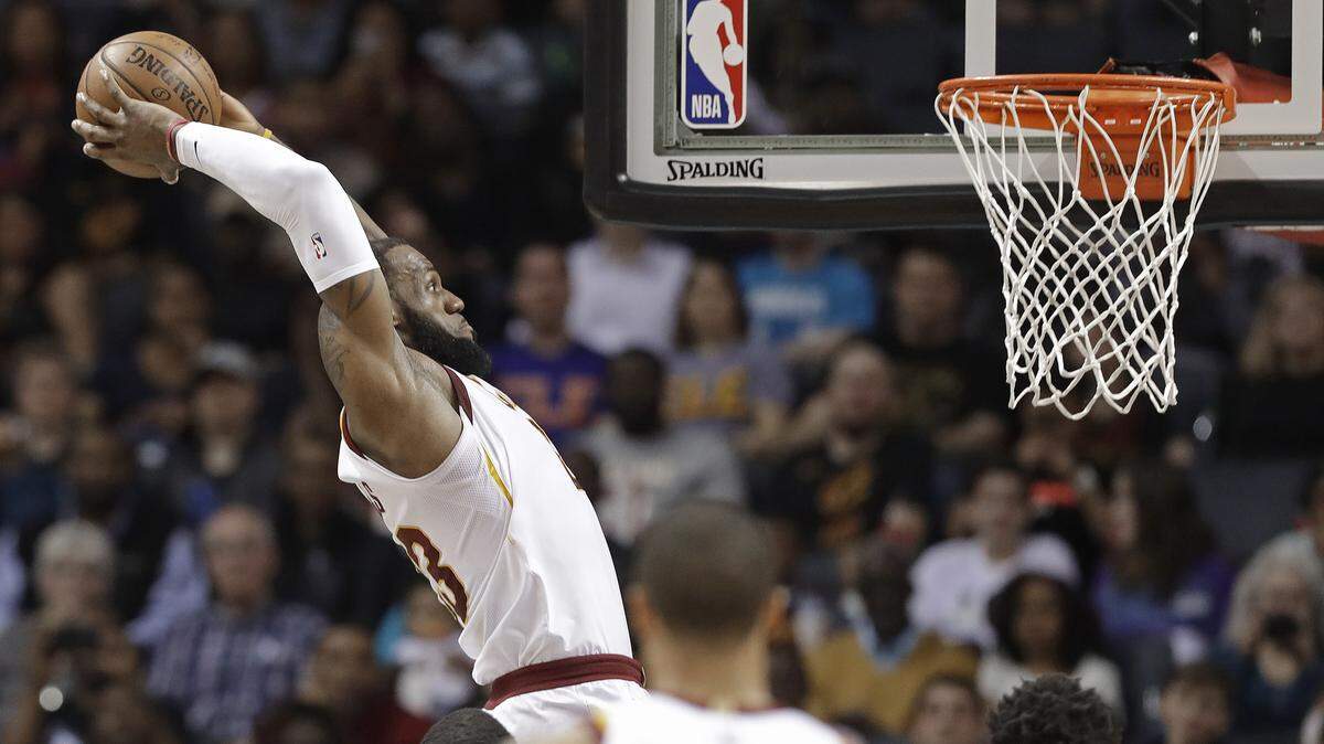 In this March 28, 2018, file photo, Cleveland Cavaliers' LeBron James goes up to dunk against the Charlotte Hornets during the first half of an NBA basketball game in Charlotte, N.C. An NBA free-agent class with a little something for everyone hits the market on July 1. The group includes an array of superstars, big men, glue guys and sharp-shooters.