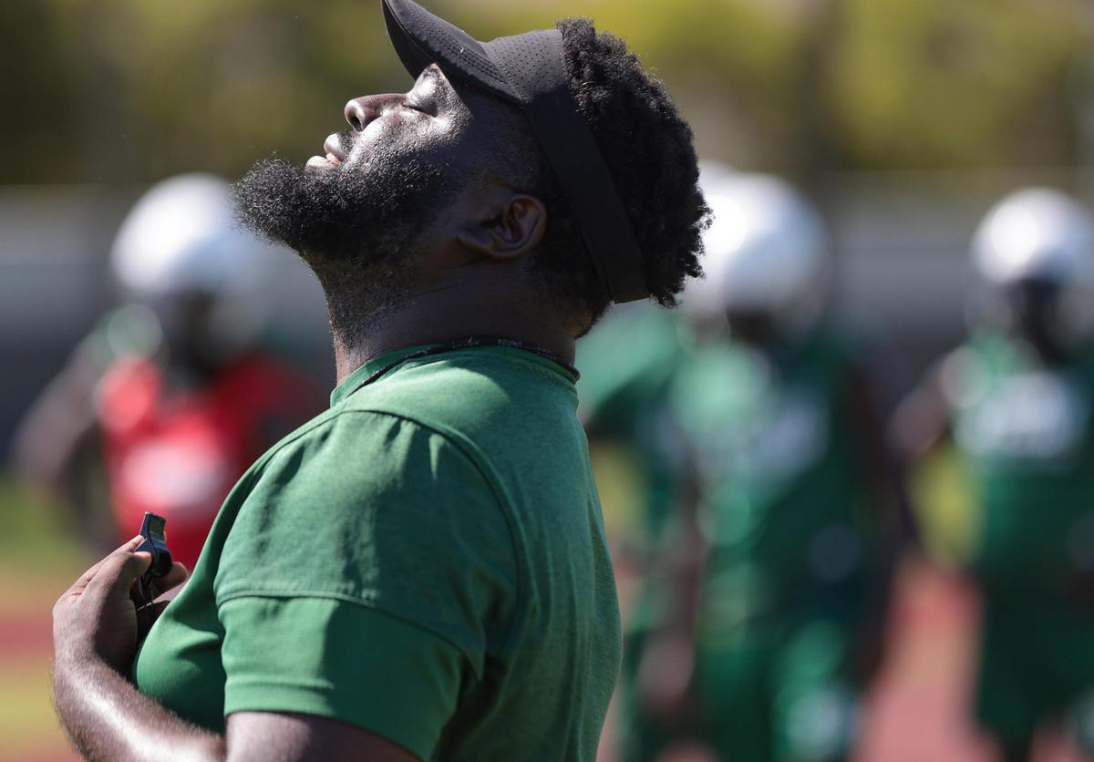On Wednesday, August 3, 2022 Miami Central High new head coach Jube Joseph looks over the team as he conducts practice at Miami Central High practice field.