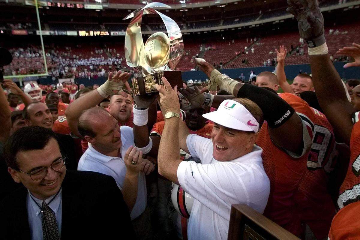 Butch Davis and the rest of the Hurricanes celebrate after being presented with the Kickoff Classic trophy against Ohio St. on Aug. 29, 1999.